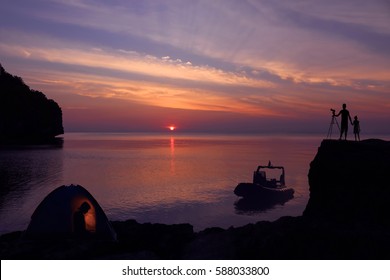 Family Camping On The Island With Private Boat And Purple Sky Sunset Background. 