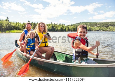 Family in a Canoe on a Lake having fun
