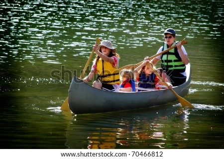 Family in a canoe on a lake in the summer