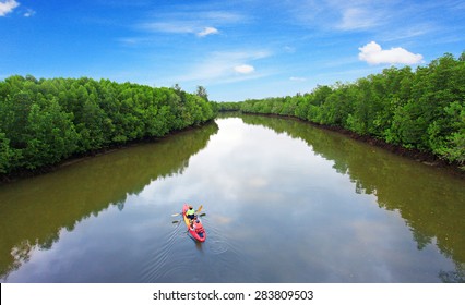 Family In A Canoe On The River.