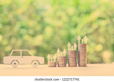 Family Car / Auto And Money Loan, Financial Concept : Sedan Car, Family Members On Stacks Of Coins On A Table, Depicts Borrowing Long-term Money From Lender / Creditor Or Bank To Purchase New Vehicle