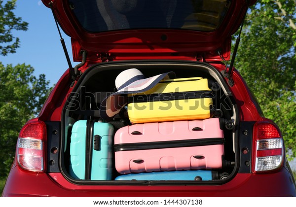Family car with open trunk full of luggage
outdoors, closeup