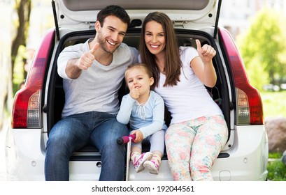 Family In Car Showing Thumbs Up