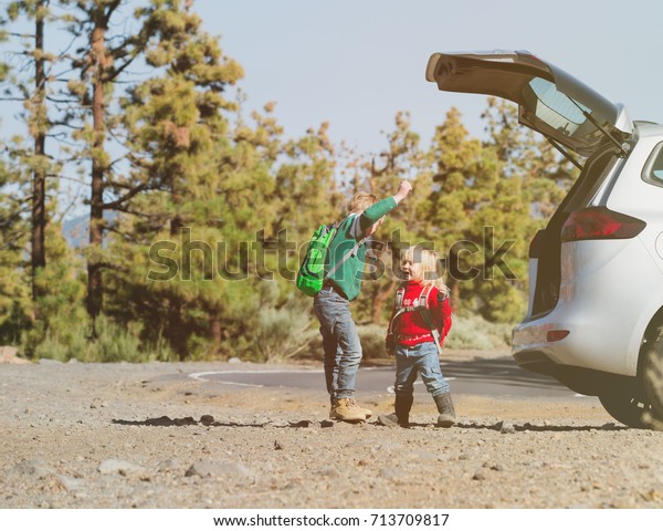family car travel - happy little boy and girl get\
ready for hiking