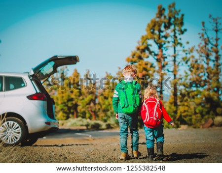 family car travel -little boy and girl get ready for hiking