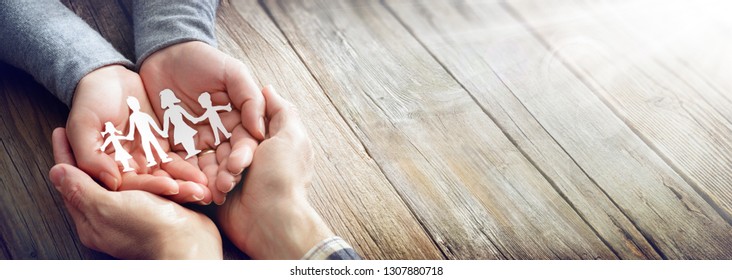 Family Care - Hands With Paper Silhouette On Table