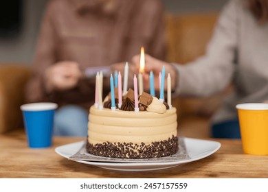 Family celebrating birthday party, lighting candles on cake.  Lifestyle people. - Powered by Shutterstock