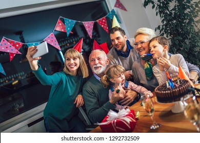 Family Celebrating Grandfather's Birthday Together And Make Selfie Photo.