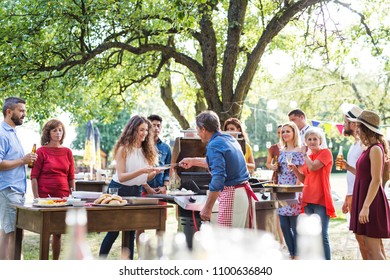 Family Celebration Or A Barbecue Party Outside In The Backyard.