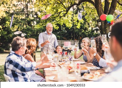 Family Celebration Or A Garden Party Outside In The Backyard.
