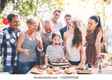 Family Celebration Or A Garden Party Outside In The Backyard.