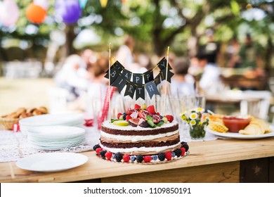 Family Celebration Or A Garden Party Outside In The Backyard.