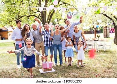 Family Celebration Or A Garden Party Outside In The Backyard.