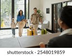 Family Checking into Hotel Lobby with Luggage