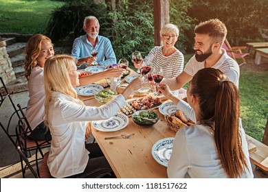 Family Cheering Over The Dining Table Outdoors, Celebration 