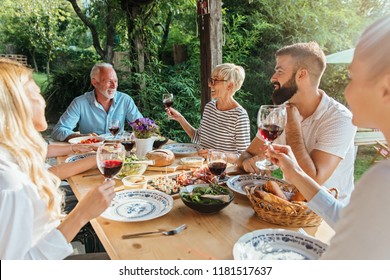 Family Cheering Over The Dining Table Outdoors, Celebration 