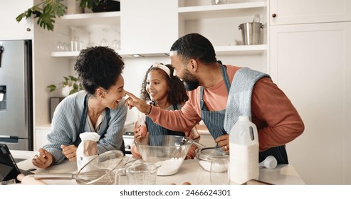 Family, child and baking or playful in kitchen, cooking and learning together with parents in apartment or culinary. Food, treat and girl preparation or fun in home, utensils and ingredients - Powered by Shutterstock