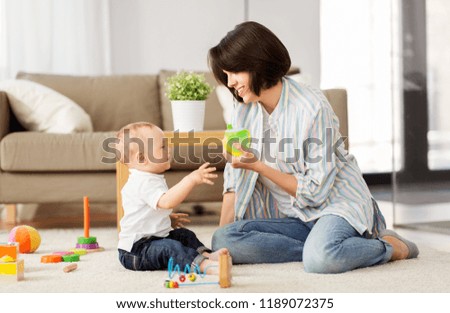 Similar – Image, Stock Photo Mother and baby playing around the Christmas Tree