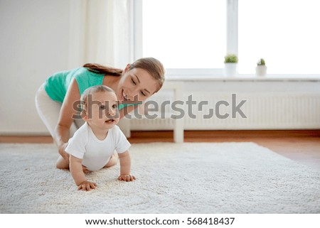 Similar – Image, Stock Photo Mother and baby playing around the Christmas Tree