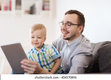 Family, Childhood, Fatherhood, Technology And People Concept - Happy Father And Son With Tablet Pc Computer Playing Or Having Video Chat At Home