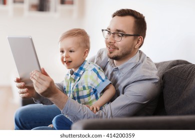 Family, Childhood, Fatherhood, Technology And People Concept - Happy Father And Son With Tablet Pc Computer Playing Or Having Video Chat At Home