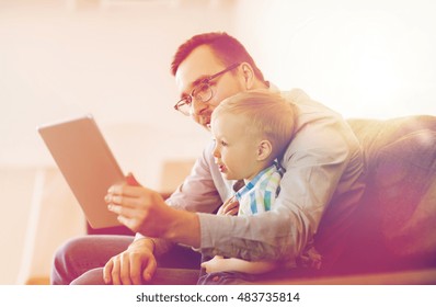 Family, Childhood, Fatherhood, Technology And People Concept - Happy Father And Son With Tablet Pc Computer Playing Or Having Video Chat At Home