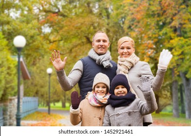 Family, Childhood, Season, Gesture And People Concept - Happy Family Waving Hands In Autumn Park