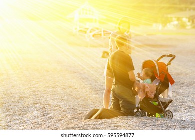 Family with children and baby carriage on the beach - Powered by Shutterstock