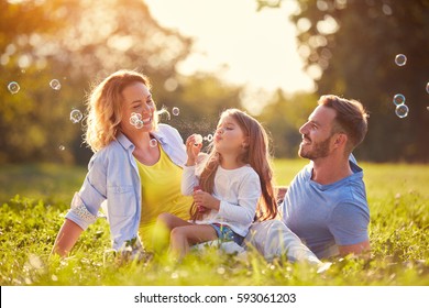 Family with children blow soap bubbles outdoor - Powered by Shutterstock