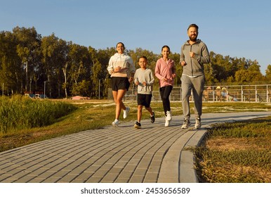 Family with children, engages in a run during the sunset in the city park. Outdoor workout captures the togetherness, promoting a fit and active lifestyle through the shared activity of exercise. - Powered by Shutterstock