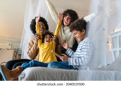 Family children gay parents concept. Happy multiethnic women couple having fun with kids at home - Powered by Shutterstock