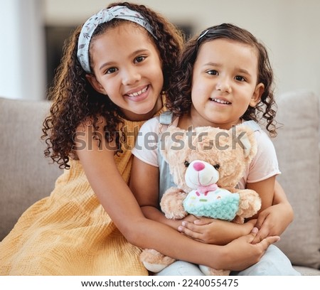 Family, children hug and portrait of girls on sofa in living room while holding teddy bear. Love, care and happy kids, sisters and siblings bonding, embrace and hugging on couch in lounge of house.