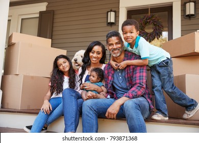 Family With Children And Pet Dog Outside House On Moving Day