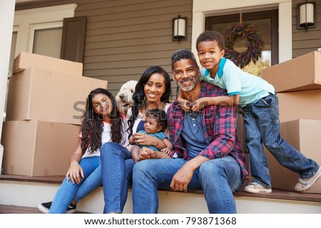 Family With Children And Pet Dog Outside House On Moving Day