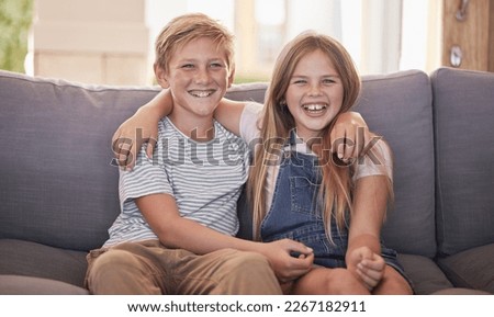 Family, children and sister and brother relax on a sofa, happy and laughing in their home together. Portrait, kids and siblings bond in a living room, sharing joke and close relationship in Amsterdam