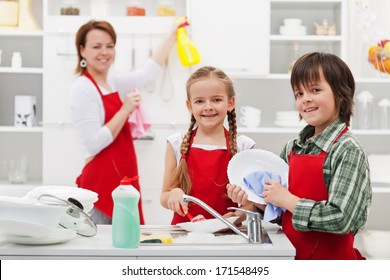 Family Cleaning The Kitchen And Washing Dishes