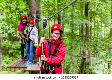 Family Climbing In High Rope Course Outdoors