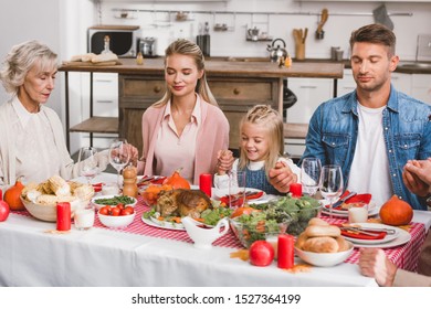 Family With Closed Eyes Holding Hands And Prying In Thanksgiving Day    