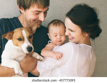 Family close-up portrait: parents, little cute baby girl and their pet - jack russel terrier dog. - Powered by Shutterstock