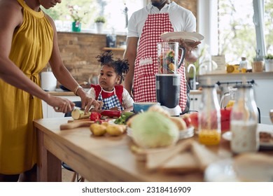  family comes together to prepare a meal in their kitchen. The image showcases a mother, father, and daughter working collaboratively, surrounded by culinary ingredients and utensils. - Powered by Shutterstock