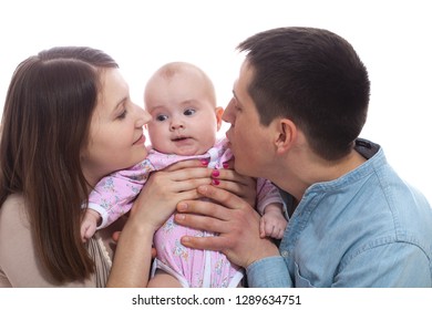 Family Concept - Baby With Dad And Mom. Portrait Of Happy Young Parents With Baby In The Bed At Home.