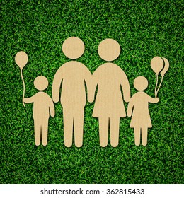 Family concept illustration with cardboard cut out on grass.