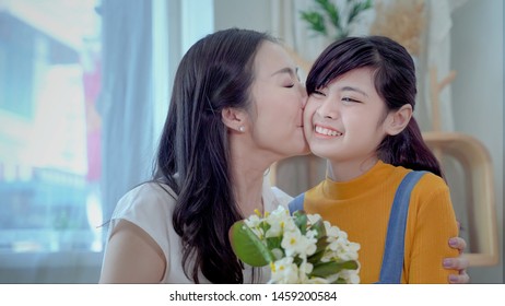Family Concept, Mother And Daughter Are Showing Love Each Other By Kissing. South East Asian Families