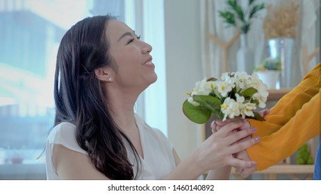 Family Concept, Mother And Daughter Are Showing Love Each Other By Giving Flowers. South East Asian Families