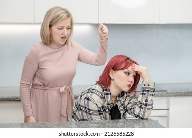 Family Conflict. Angry Mother Screams At Afraid Teen Daughter