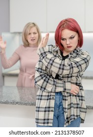 Family Conflict. Angry Mother Screams At Afraid Teen Daughter, Girl Ignoring Her Mom And Shows Stop Gesture. Family Relationships