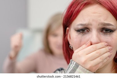 Family Conflict. Angry Mother Screams At Crying Teen Daughter