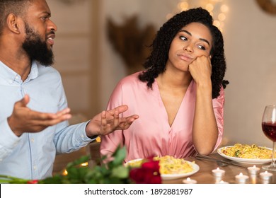 Family Conflict. Unhappy Sad African American Woman Sitting On Date In Restaurant, Having Unpleasant Conversation With Arguing Husband, Thinking About Breakup And Divorce. Relationship Problem