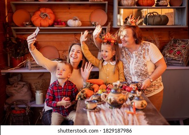 Family Congratulates Friends On Thanksgiving Online. Video Chatting With Friends New Normal. Festive Dinner Remotely By Phone On A Smartphone. Social Distance Pandemic Covid-19. Celebrating Tradition