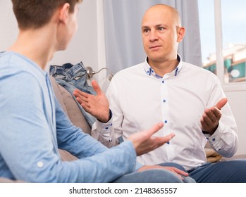 Family Conversation Between Father And Teenage Son In Home Interior